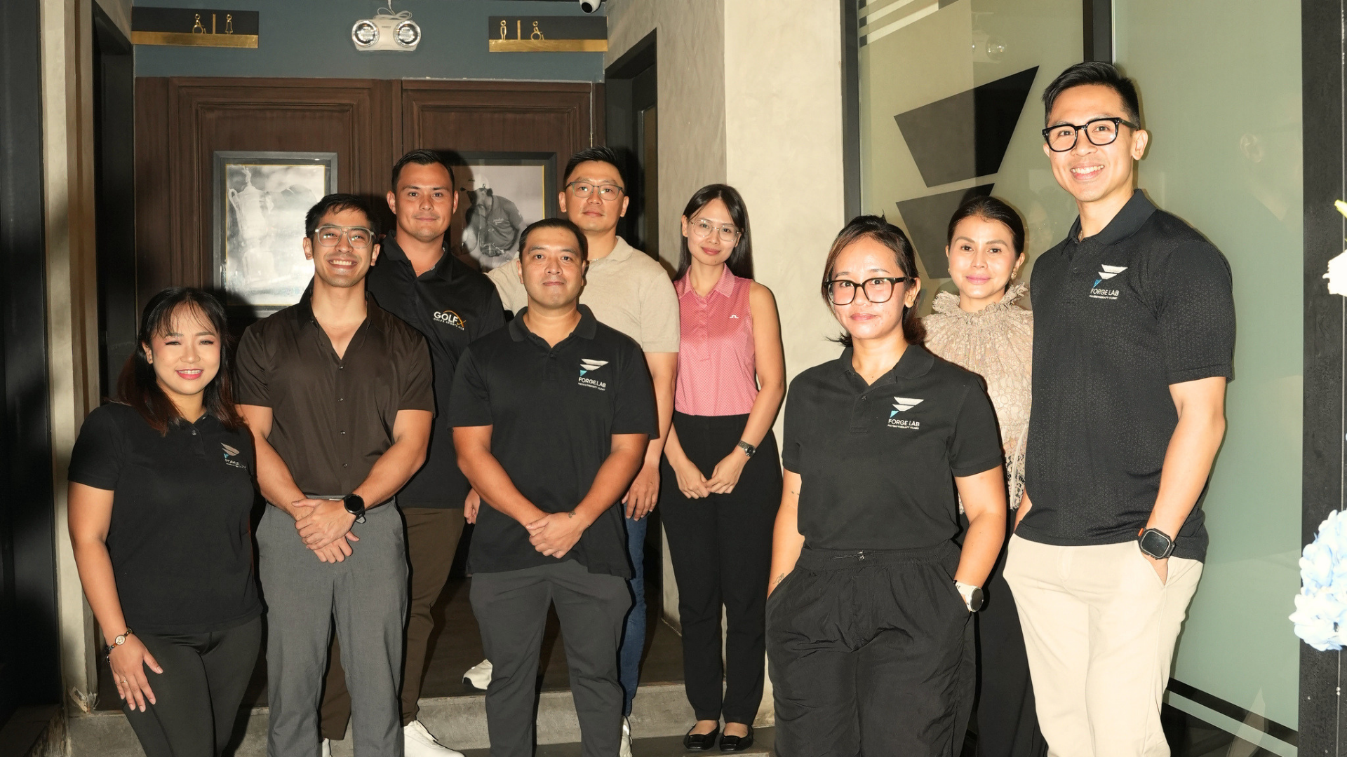 Forge Lab team and guests at the BGC clinic entrance inside GolfX Sportshub